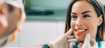 A woman undergoing a cosmetic dentistry consultation
