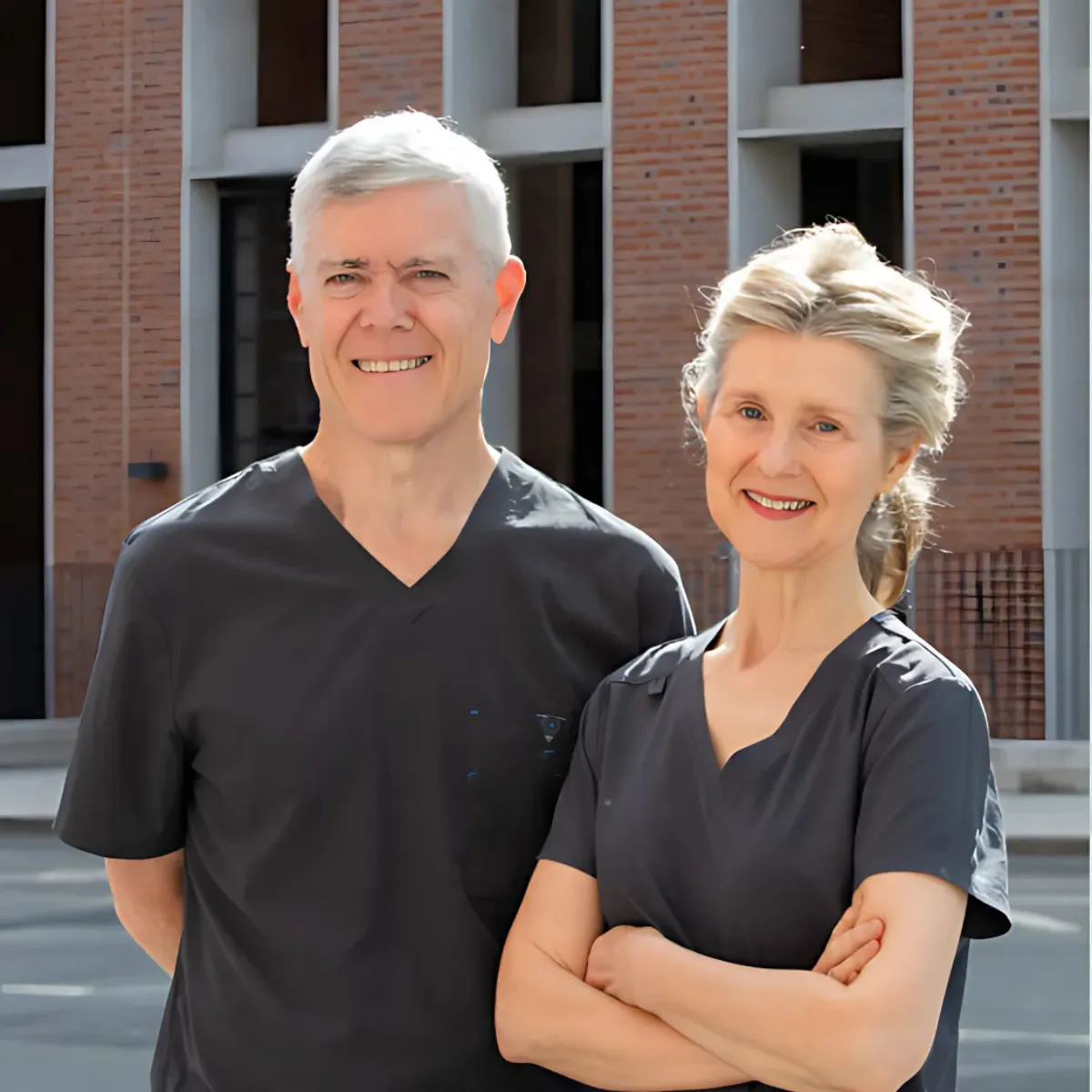 A professional photo of Dr Ray McCarthy and Dr Susan Kiely, previously of Fitzwilliam Dental wearing scrubs standing outside the Northumberland practice.