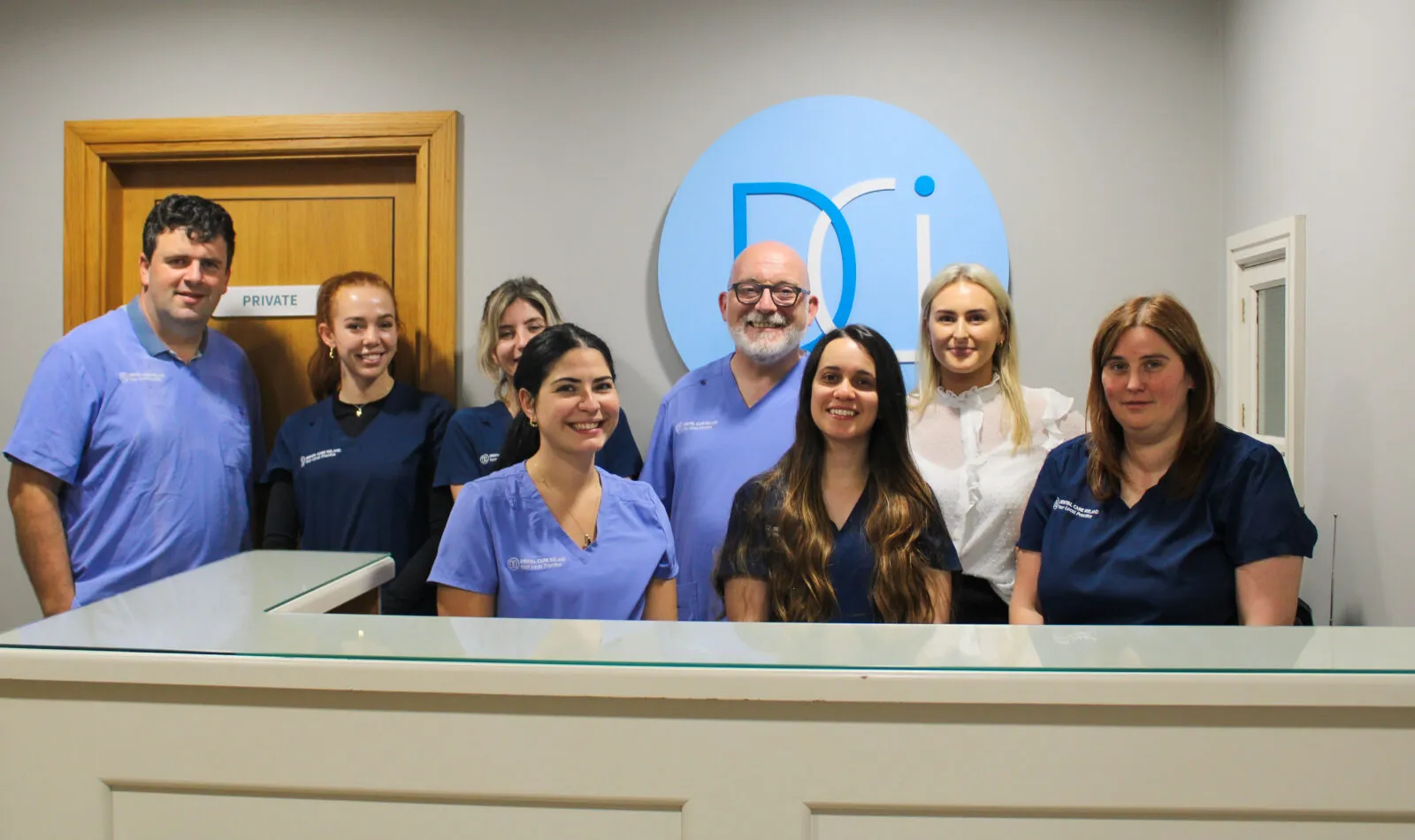 A group photo of the Limerick Dental team at the reception desk.