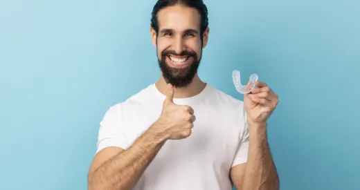 Mouthguards blog image, man holding a mouthguard