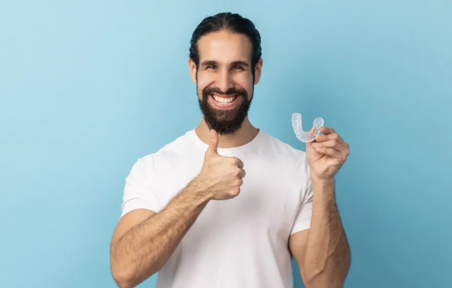 Mouthguards blog image, man holding a mouthguard