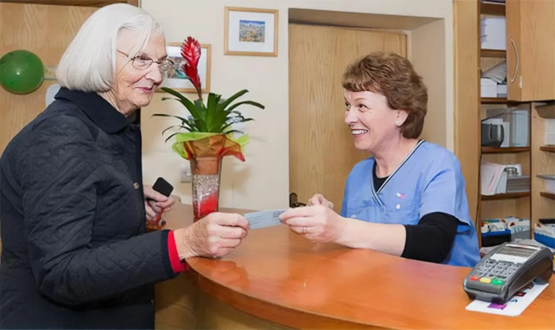 Dental Care Ireland Athenry Receptionist at desk with Client